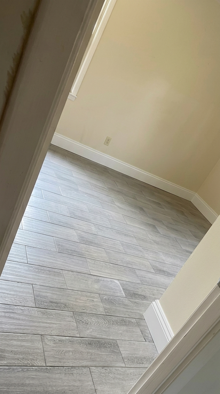After — new gray wood-look tile with white baseboard, Waverly GA Waverly GA room with new gray wood-look tile flooring and fresh white baseboard trim installed