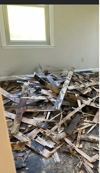 Before — old flooring torn out to the subfloor, Waverly GA Waverly GA room with the old flooring torn out and debris piled on the bare subfloor before new tile